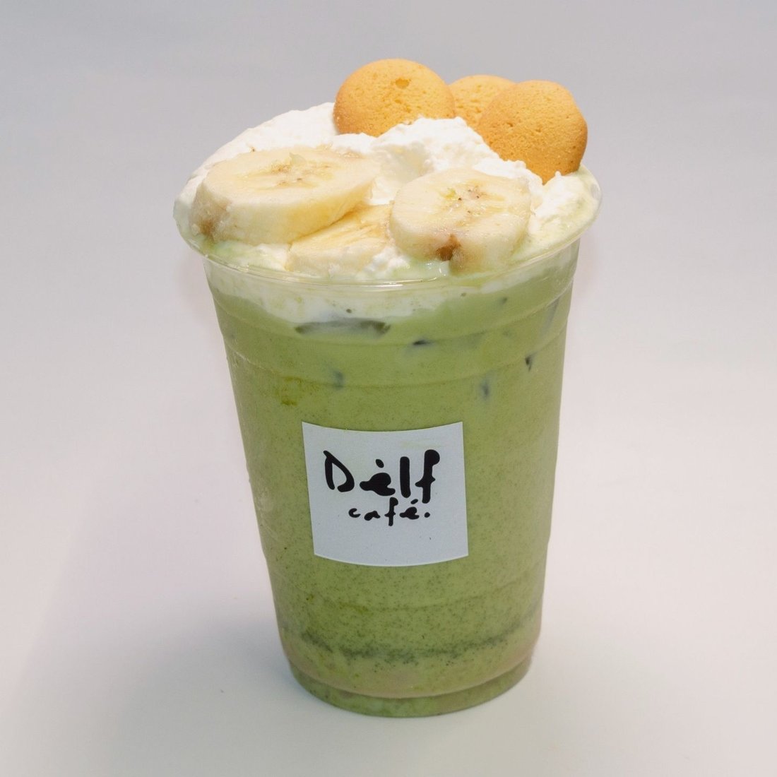 Banana bread matcha with whipped cream, fresh banana and vanilla wafers at Dèlf Café
