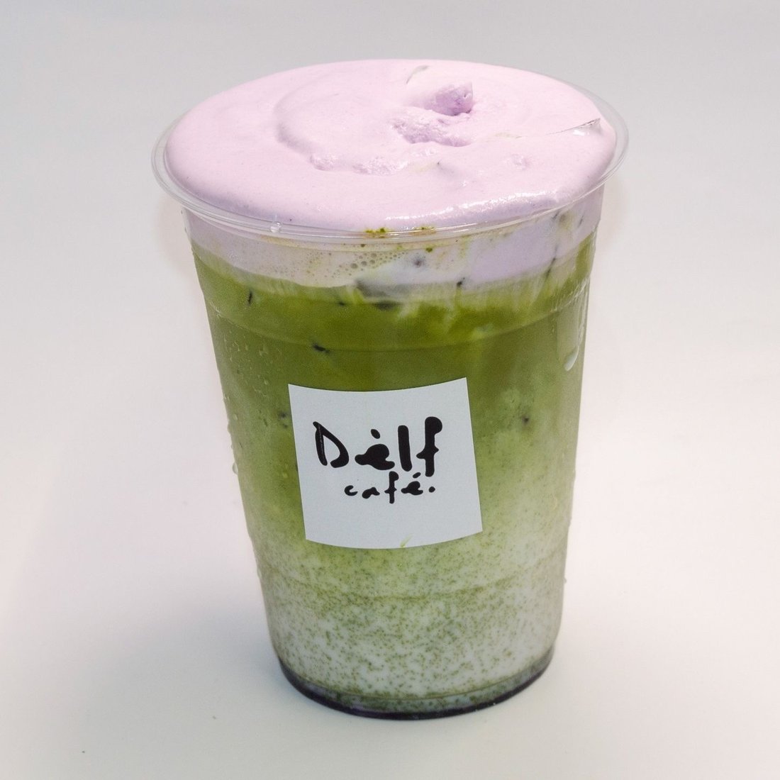 Iced matcha latte topped with strawberry cream foam at Dèlf Café