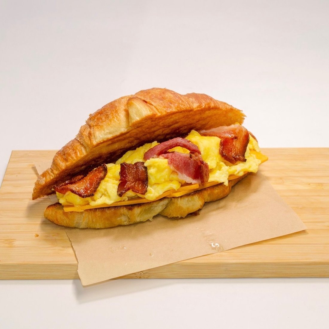 Breakfast croissant with scrambled egg, bacon and cheddar at Dèlf Café