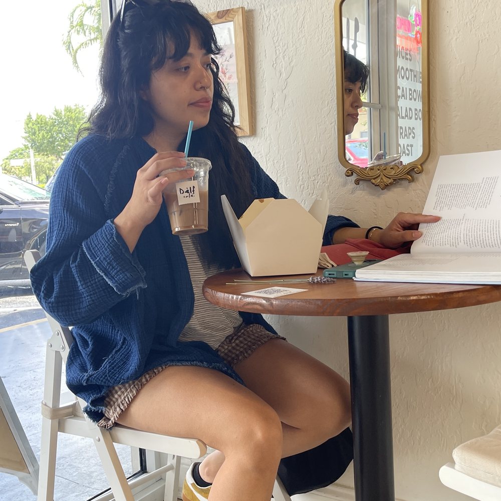 Guest seated by the window at Dèlf Café in Sunrise, FL